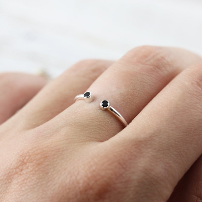 Open ring with two black stones