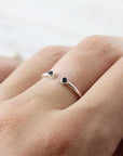 Open ring with two black stones