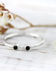 Open ring with two black stones