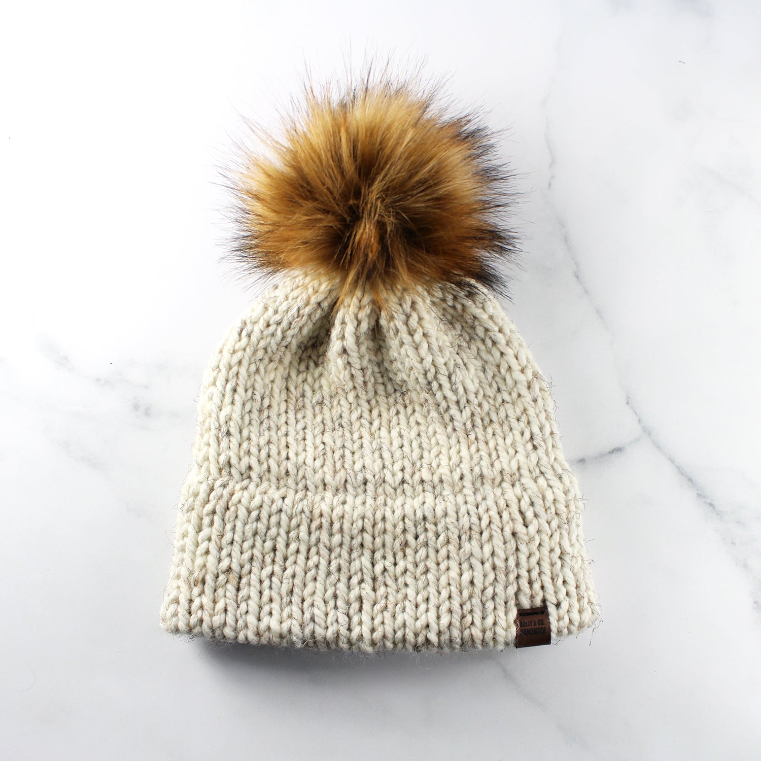 Wheat-colored pompom hat